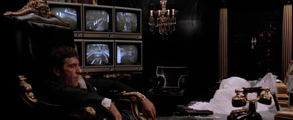 Tony Montana watching security camera monitors in Scarface